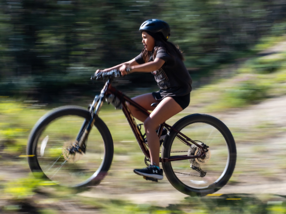 bouncing-pika-girl-riding-mountain-bike-in-forest-trail