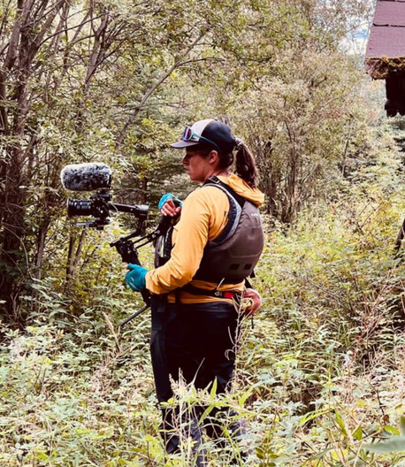 woman-with-camera-in-nature-videography-adventure-exploration